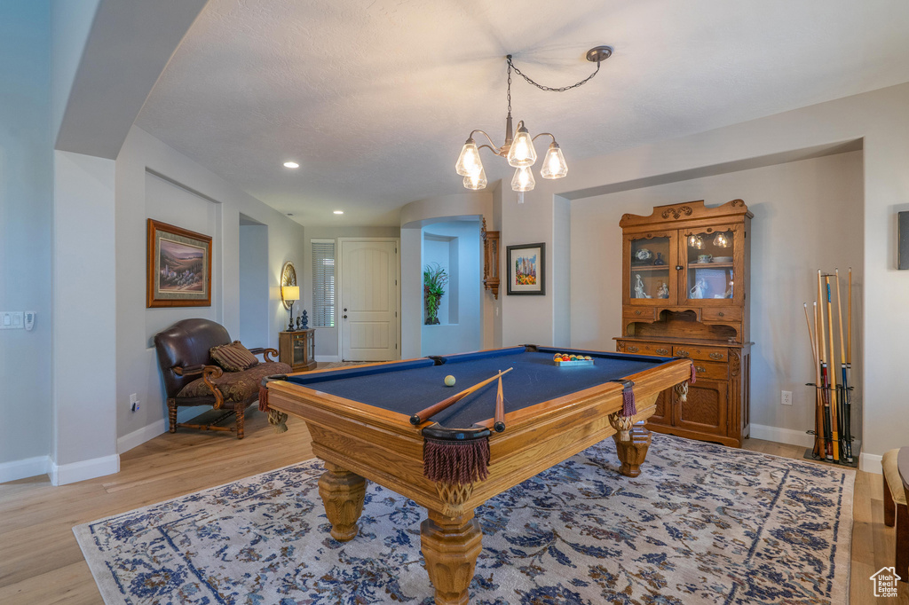 Rec room featuring light wood-style flooring, arched walkways, recessed lighting, and pool table