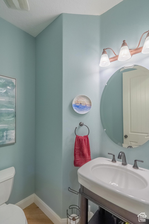 Bathroom with wood finished floors and vanity