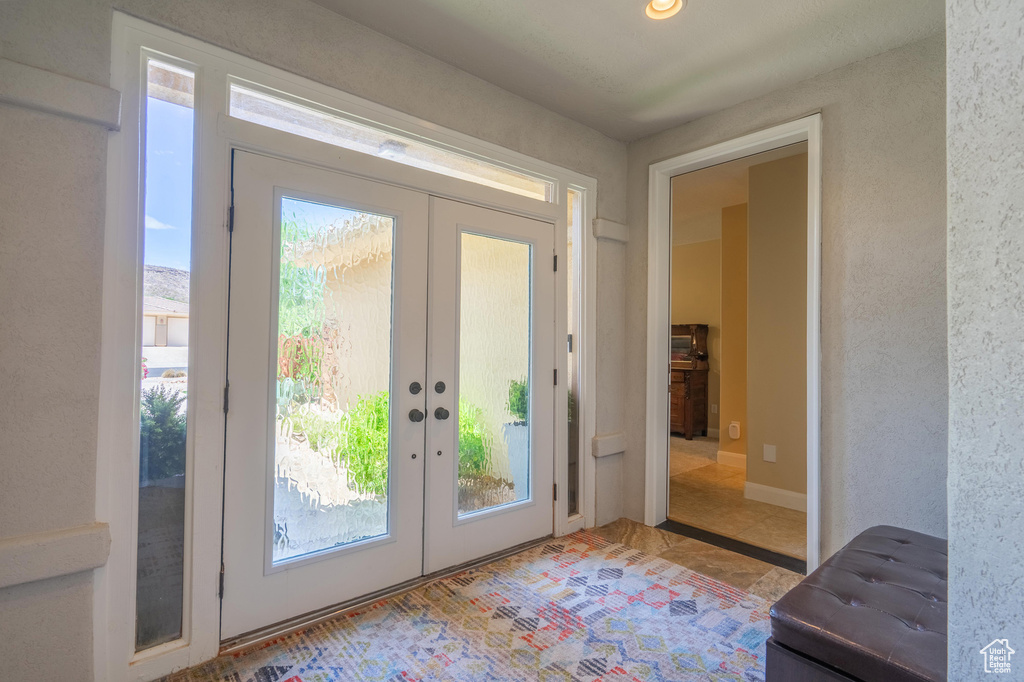 Doorway to outside with french doors and healthy amount of natural light