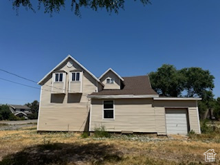 Rear view of house featuring an attached garage