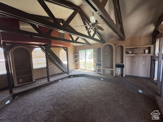 Unfurnished living room featuring vaulted ceiling, carpet, and a ceiling fan