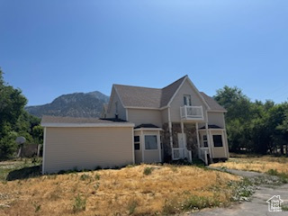 View of front facade with a balcony and a mountain view