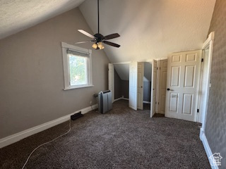 Additional living space with vaulted ceiling, a ceiling fan, and carpet floors