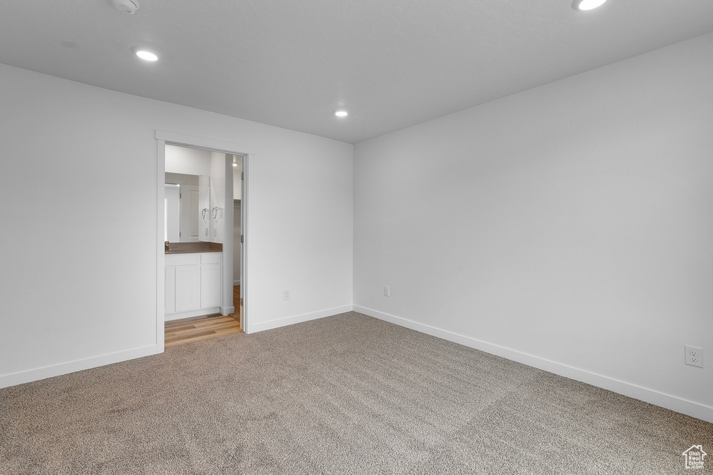 Unfurnished room with light colored carpet and recessed lighting