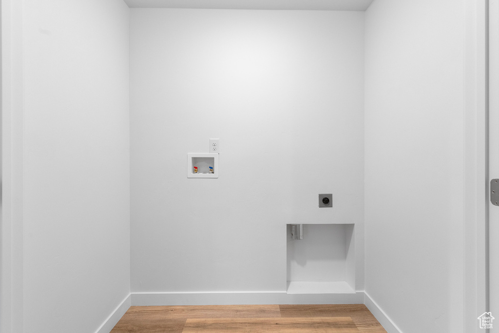 Washroom featuring electric dryer hookup, washer hookup, and light wood-style floors