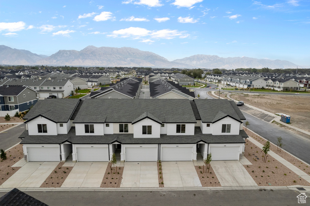 Aerial perspective of suburban area featuring a mountain backdrop