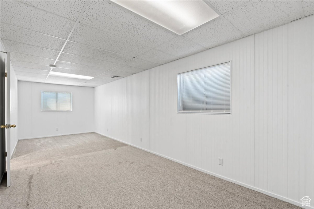 Spare room featuring a paneled ceiling and carpet floors