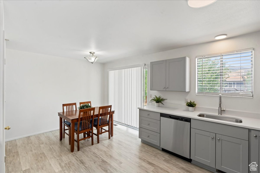 Kitchen featuring dishwasher, gray cabinetry, light wood finished floors, and light countertops