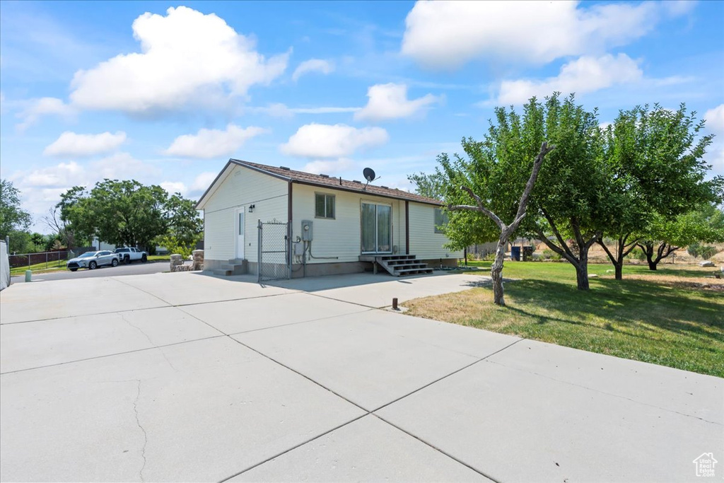 Single story home featuring entry steps and a front lawn