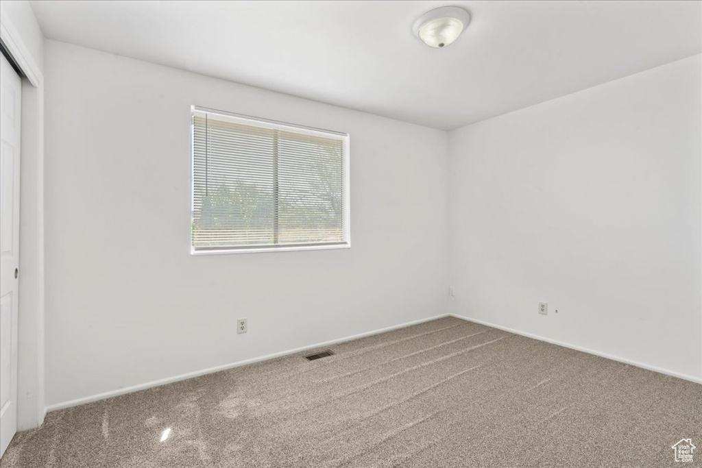 Unfurnished room with carpet floors and baseboards