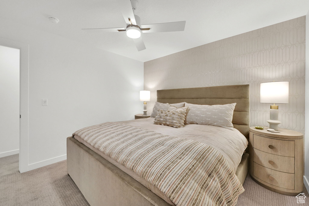 Bedroom featuring light colored carpet and ceiling fan