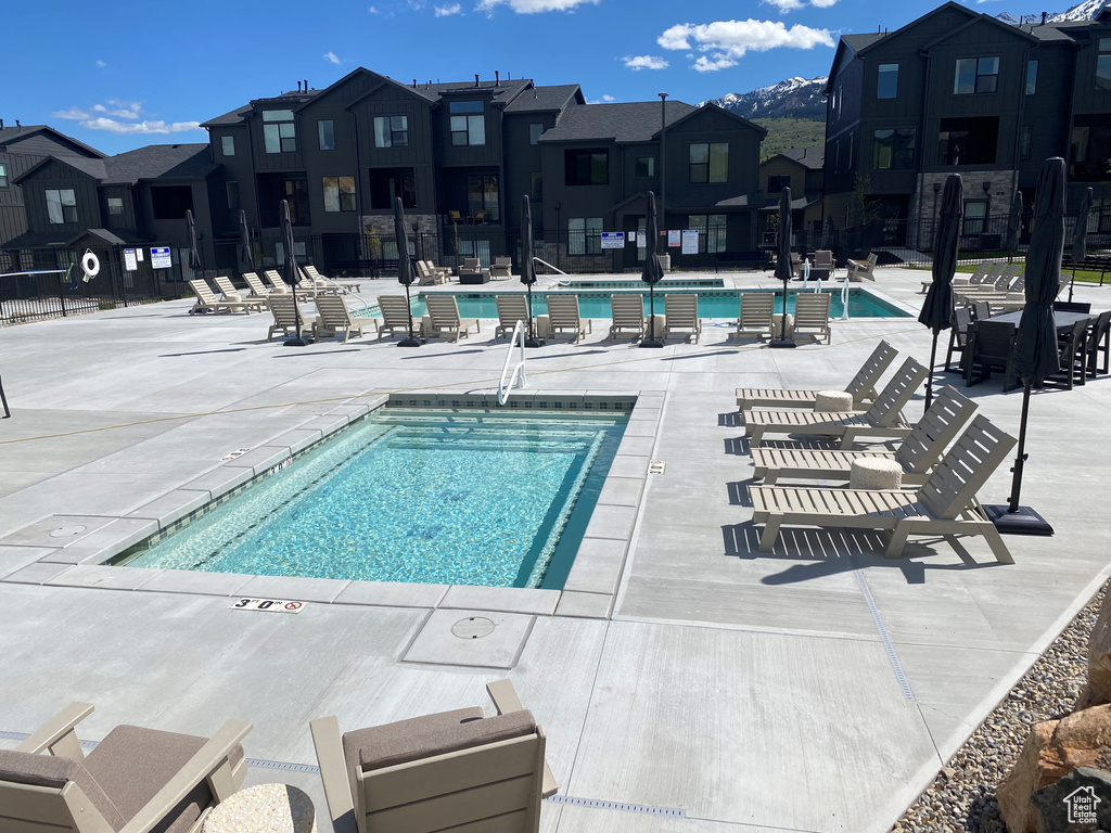 Community pool featuring a residential view and a patio area