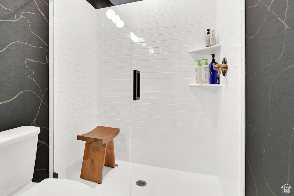 Bathroom with a stall shower and toilet