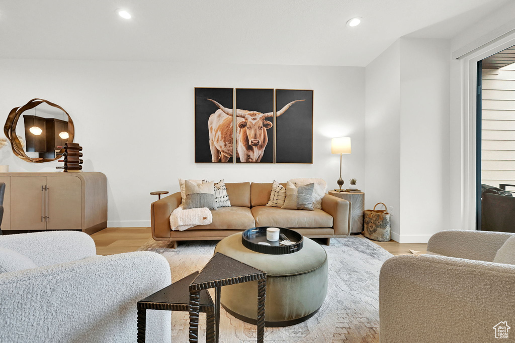 Living area with wood finished floors and recessed lighting