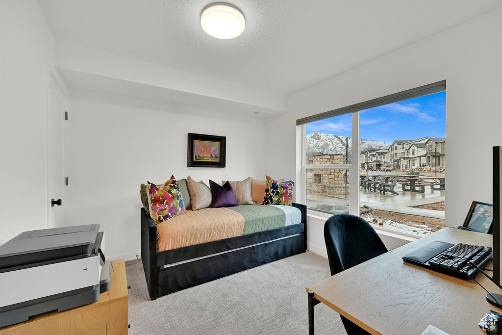 Bedroom with an office area and baseboards