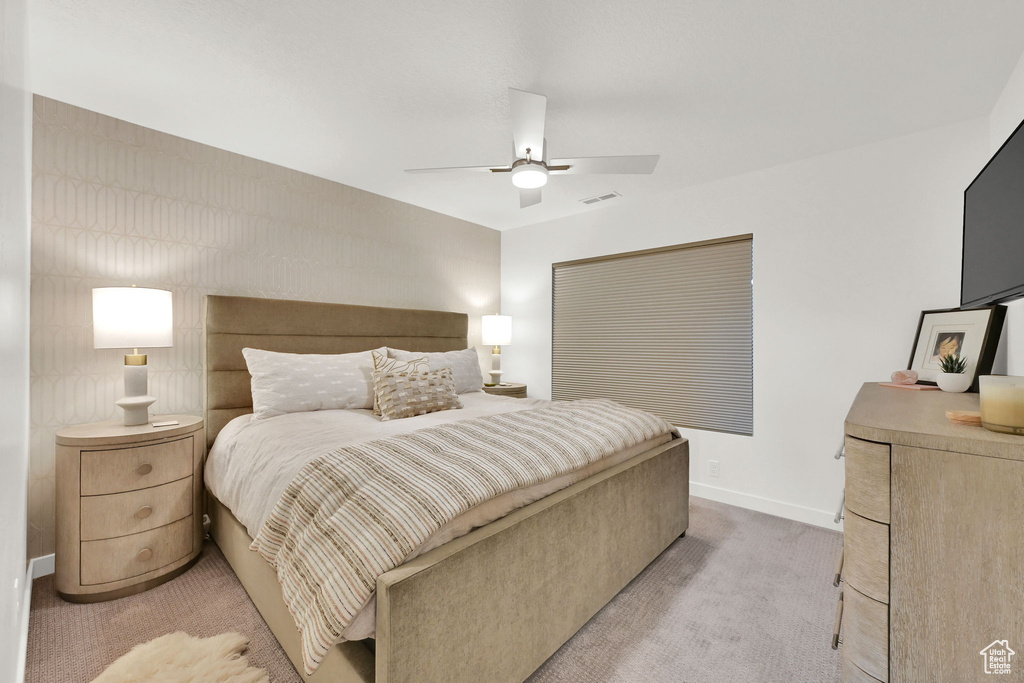Bedroom featuring light colored carpet and a ceiling fan