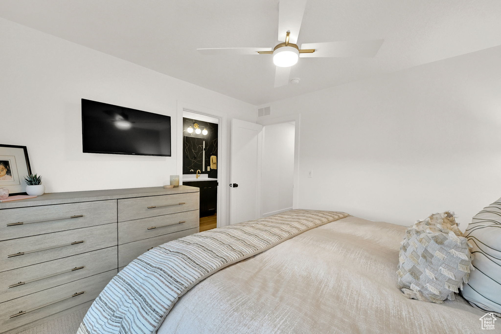 Bedroom featuring a ceiling fan and connected bathroom