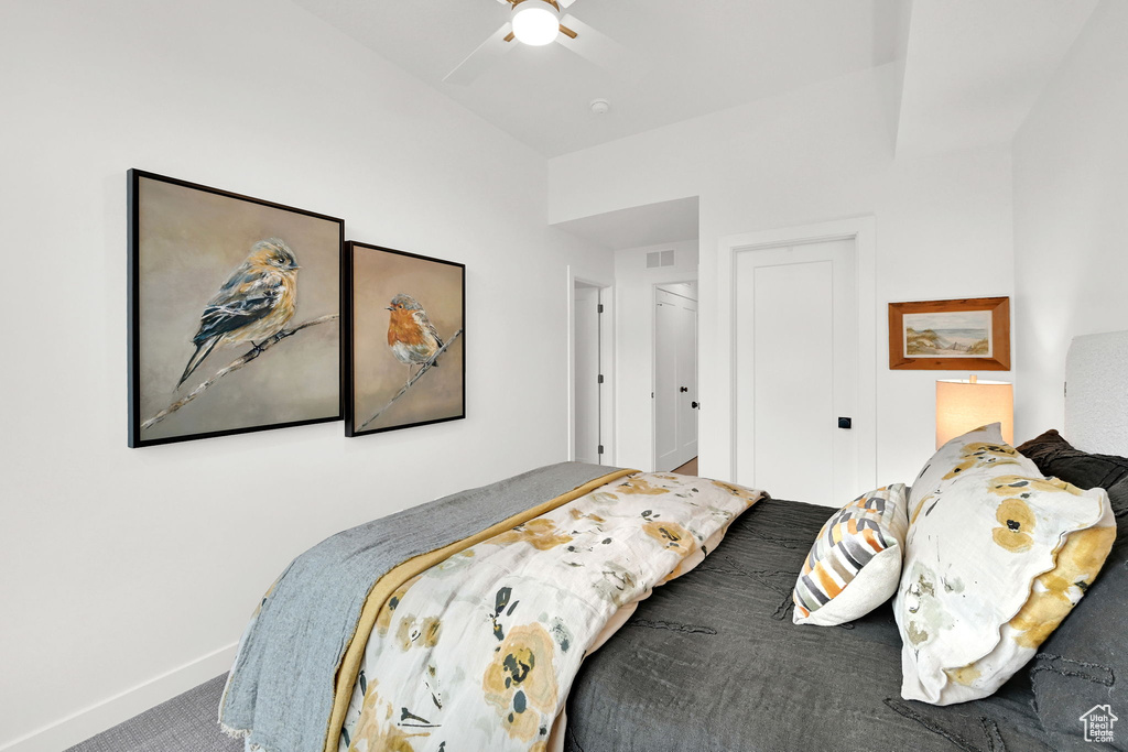 Carpeted bedroom featuring baseboards and ceiling fan