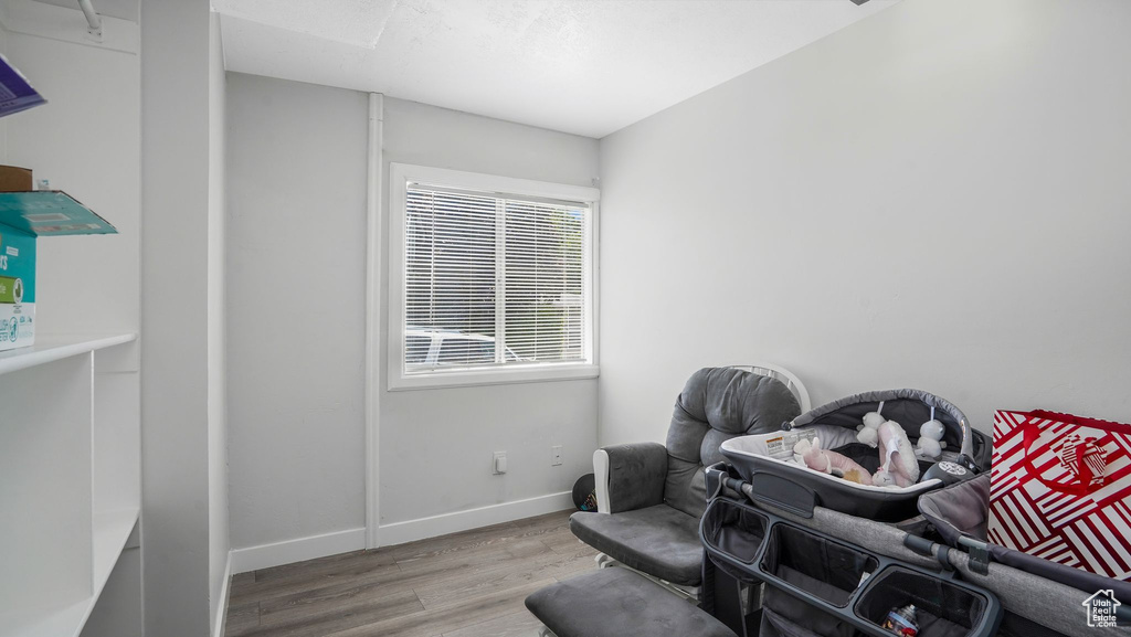 Sitting room with wood finished floors and baseboards
