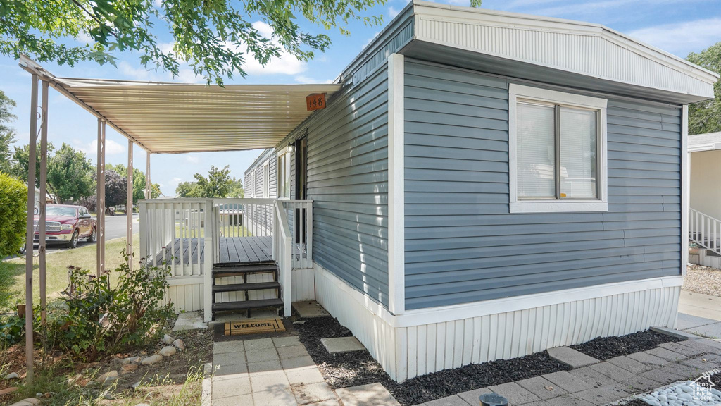 View of side of property featuring a carport