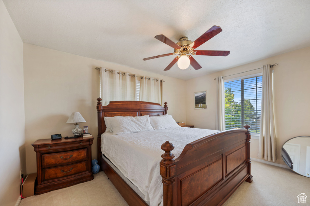 Bedroom with light carpet and ceiling fan