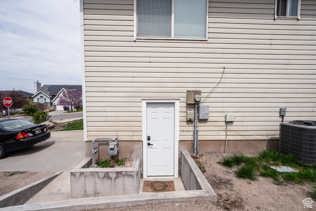 View of exterior entry featuring cooling unit