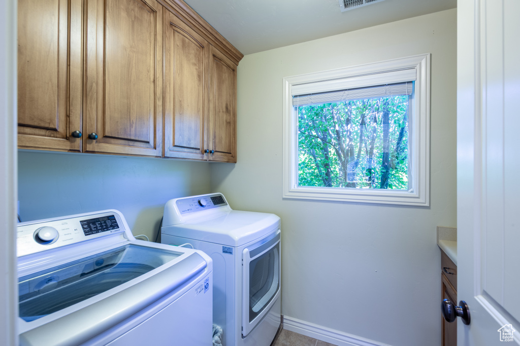 Washroom with washing machine and dryer and cabinet space