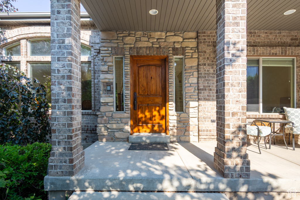 Doorway to property with brick siding and stone siding