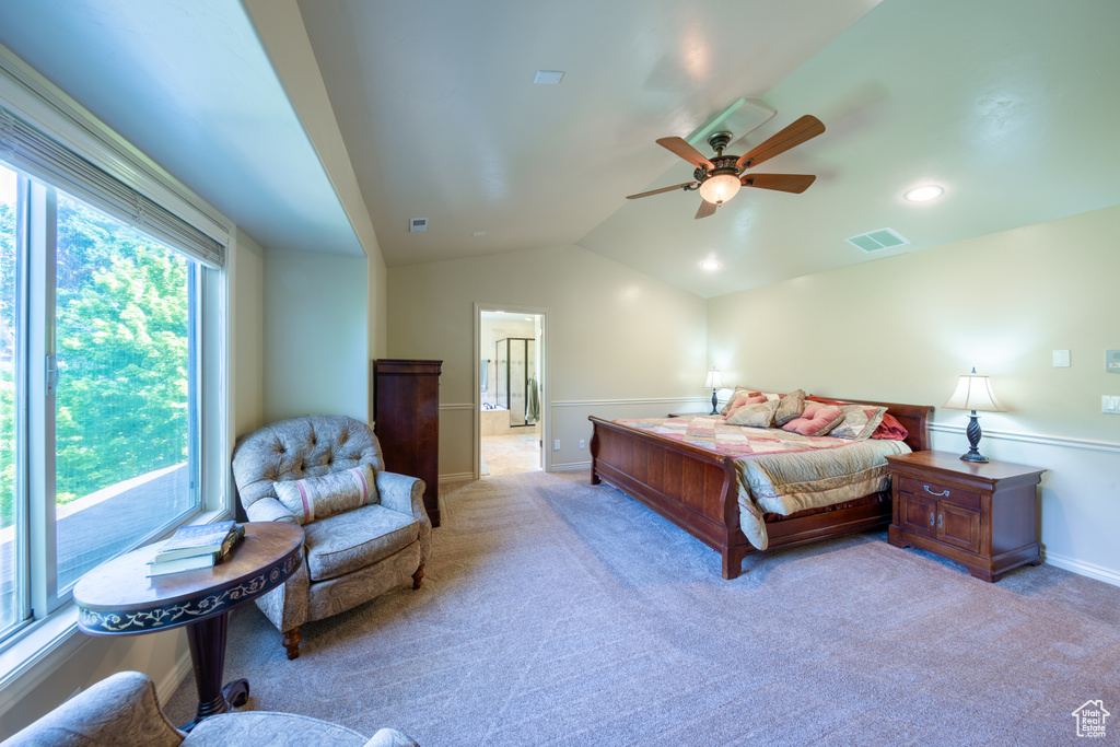 Carpeted bedroom featuring lofted ceiling and a ceiling fan