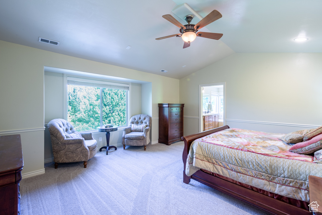 Carpeted bedroom with lofted ceiling and ceiling fan