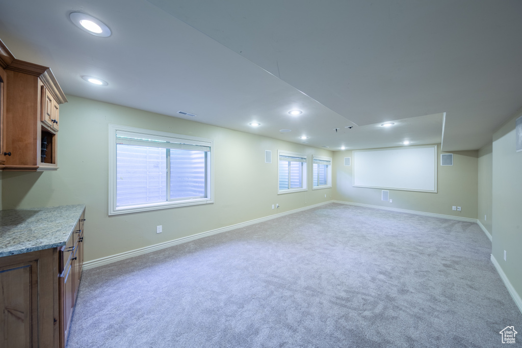 Below grade area featuring recessed lighting and light colored carpet