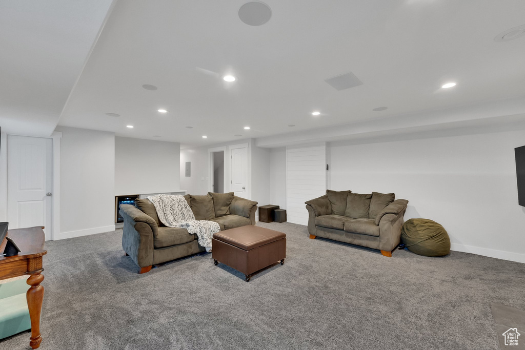Carpeted living area featuring recessed lighting and baseboards
