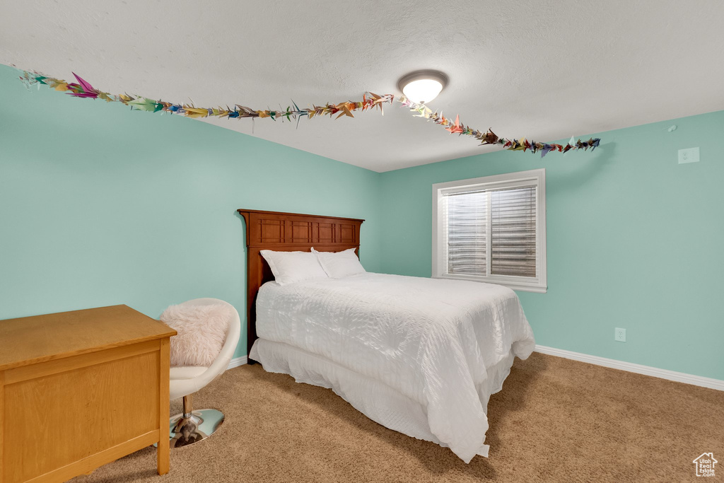 Bedroom with light carpet and baseboards
