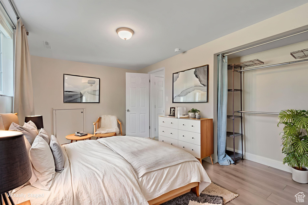 Bedroom with light wood-style floors and a closet