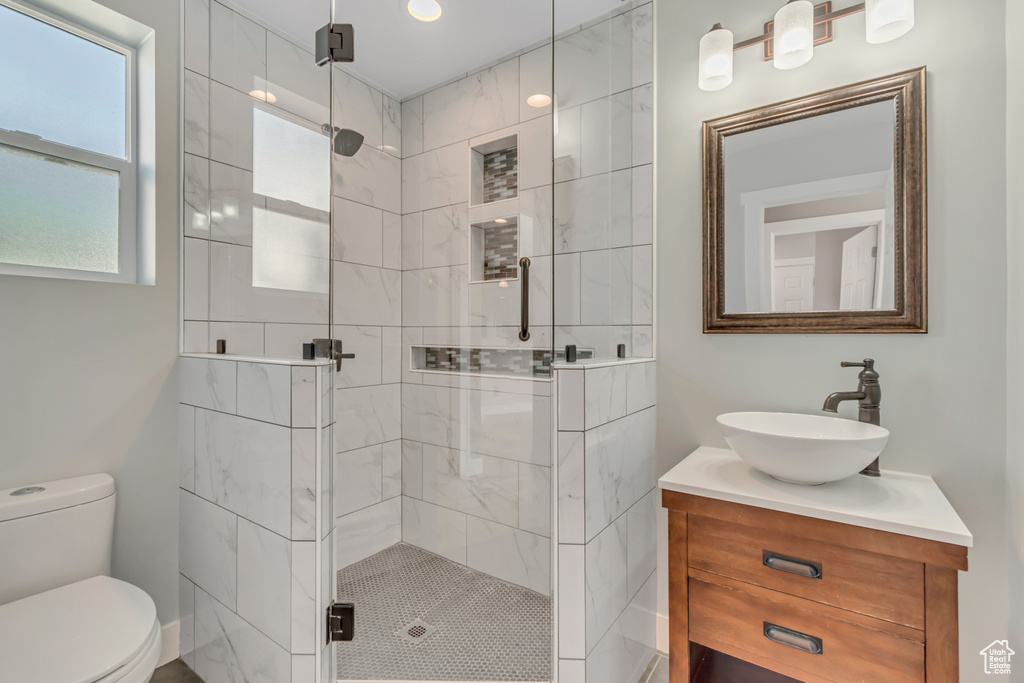 Bathroom with a shower stall and vanity