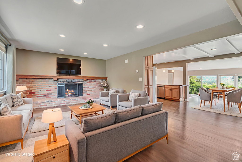 Living area featuring a fireplace, light wood-type flooring, and recessed lighting
