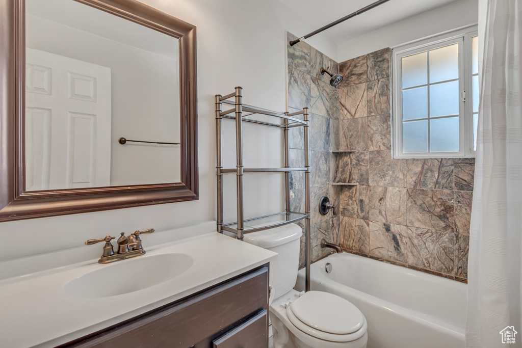 Bathroom with shower / tub combo and vanity