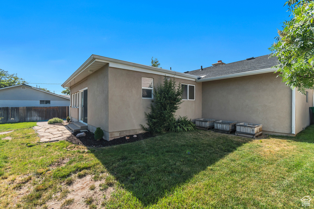 Rear view of property featuring stucco siding and a patio area