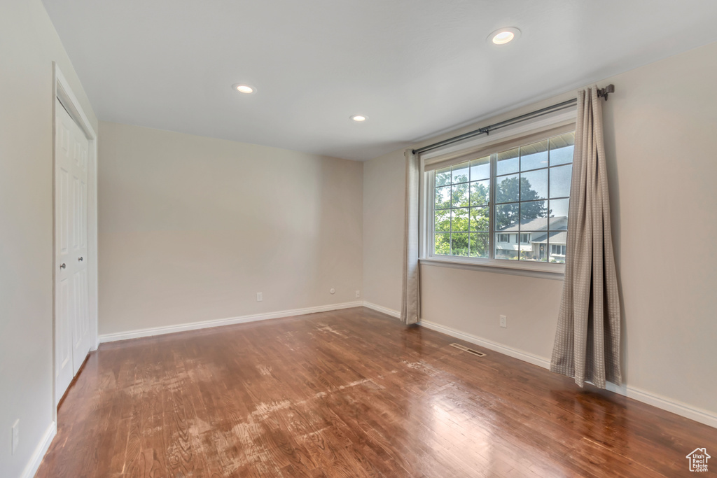 Empty room featuring wood finished floors and recessed lighting
