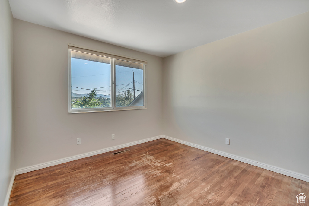 Spare room featuring wood finished floors