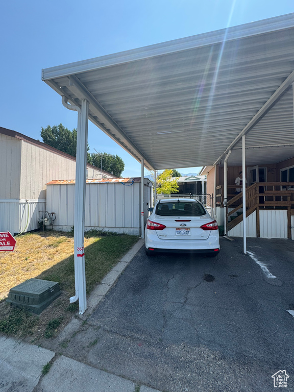 View of parking with a carport