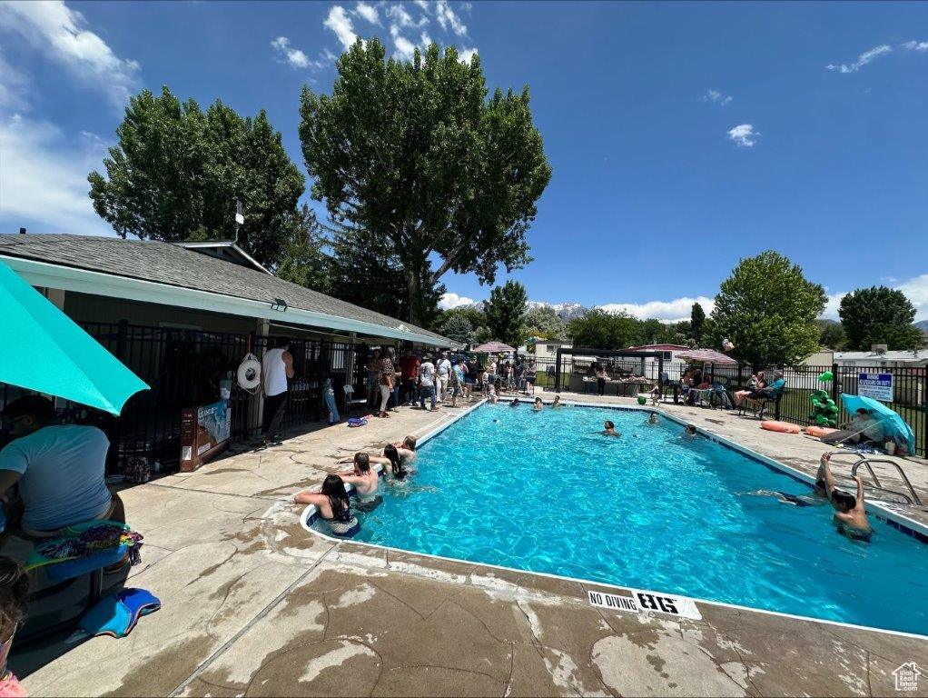 Community pool featuring a patio