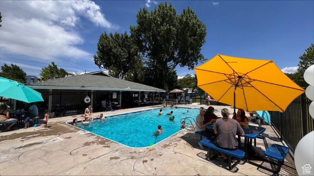 Community pool with a patio