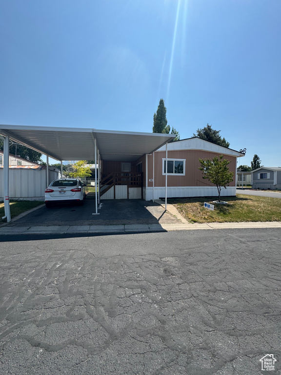 View of car parking featuring an attached carport