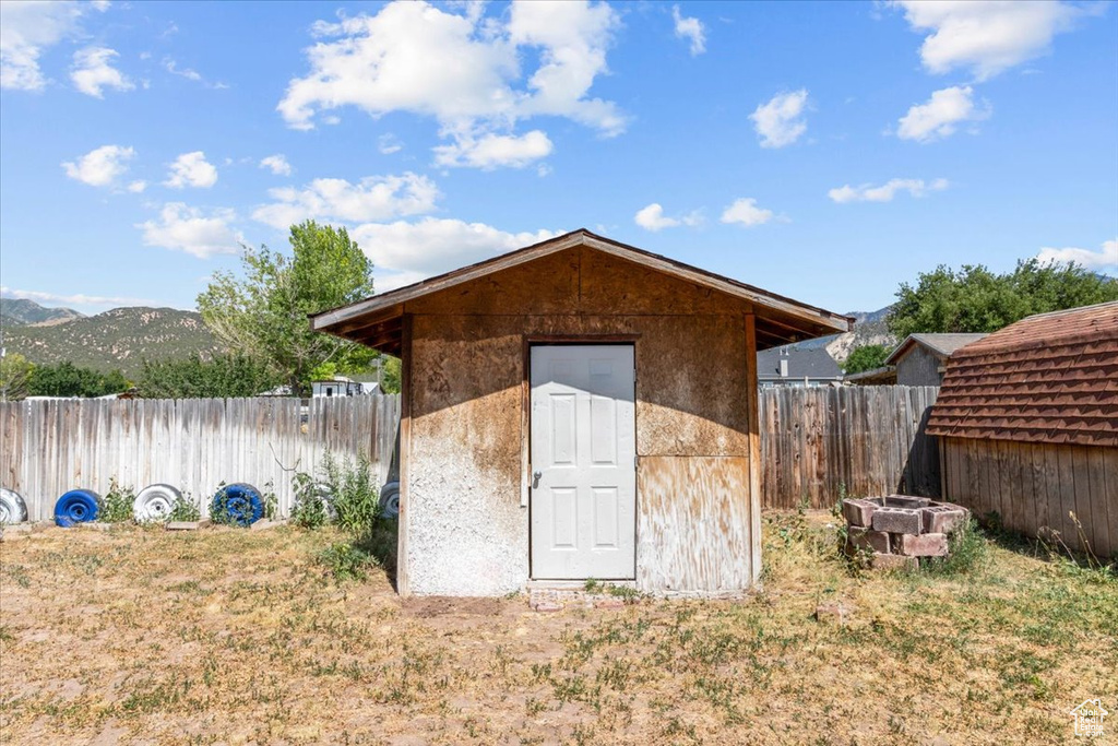 View of shed featuring a fenced backyard and a mountain view