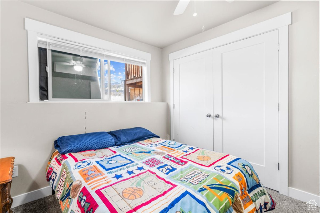 Bedroom featuring carpet floors, ceiling fan, and a closet