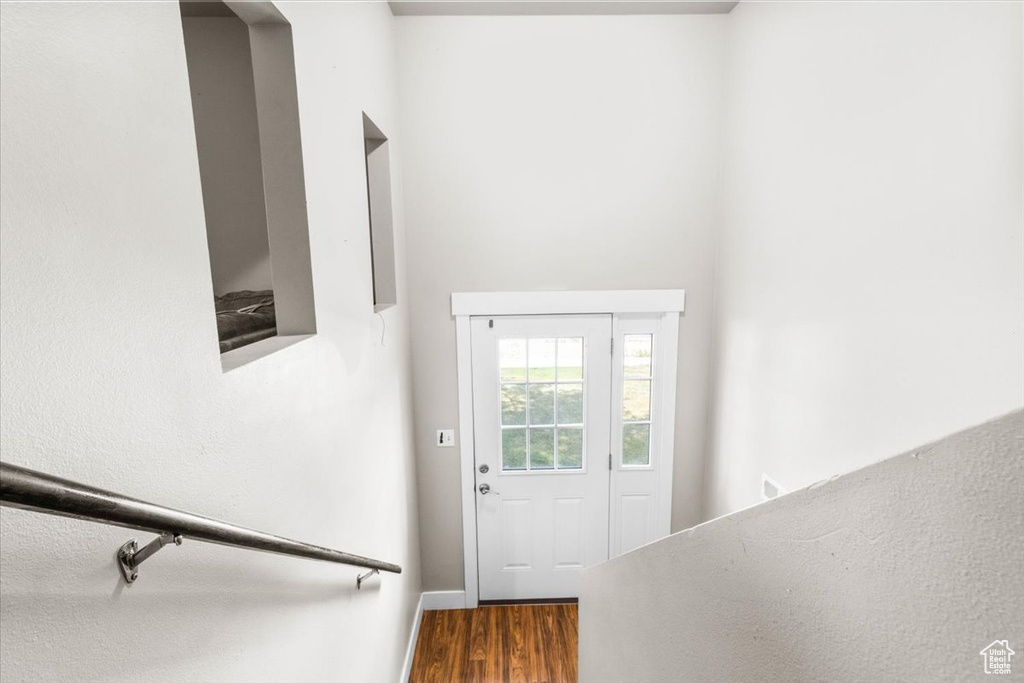 Doorway featuring wood finished floors and baseboards