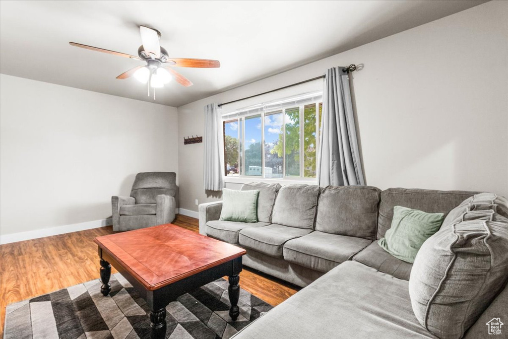 Living area featuring wood finished floors and ceiling fan