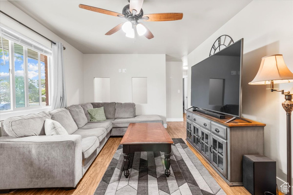 Living area with wood finished floors and a ceiling fan