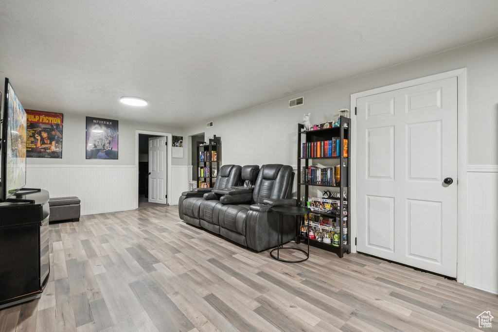 Living room featuring wainscoting and light wood finished floors